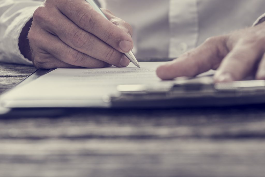 Toned image of male hand signing business contract